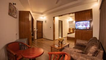 Luxury Studio Suite | Living area | Flat-screen TV
