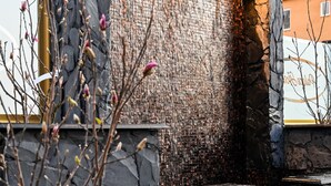 A stone wall with a water feature and a small waterfall. - Palace Hotell (Hultsfred)