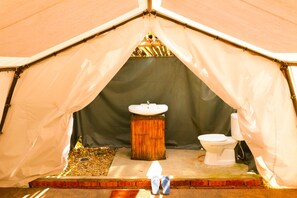 A tent with a bathroom area including a sink and toilet. - Caravan Serai Exclusive Private Villas & Eco Resort (Bentong)