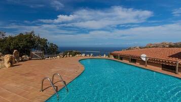Enjoy a refreshing swim with a clear view of the ocean from the pool surrounded by a deck.