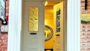 A hotel entrance with a white door, a brick wall, and a sign indicating the room number 49. - Belizia Hotel (Istanbul)