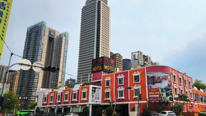 A hotel with a red facade, multiple windows, and a sign indicating it is a hotel. - HE&LE Design Hotel (Taichung)