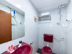 A bathroom with a red sink, a mirror, a toilet, a shower, and a towel rack. - Hotel O My 7days Inn (Pasir Gudang)