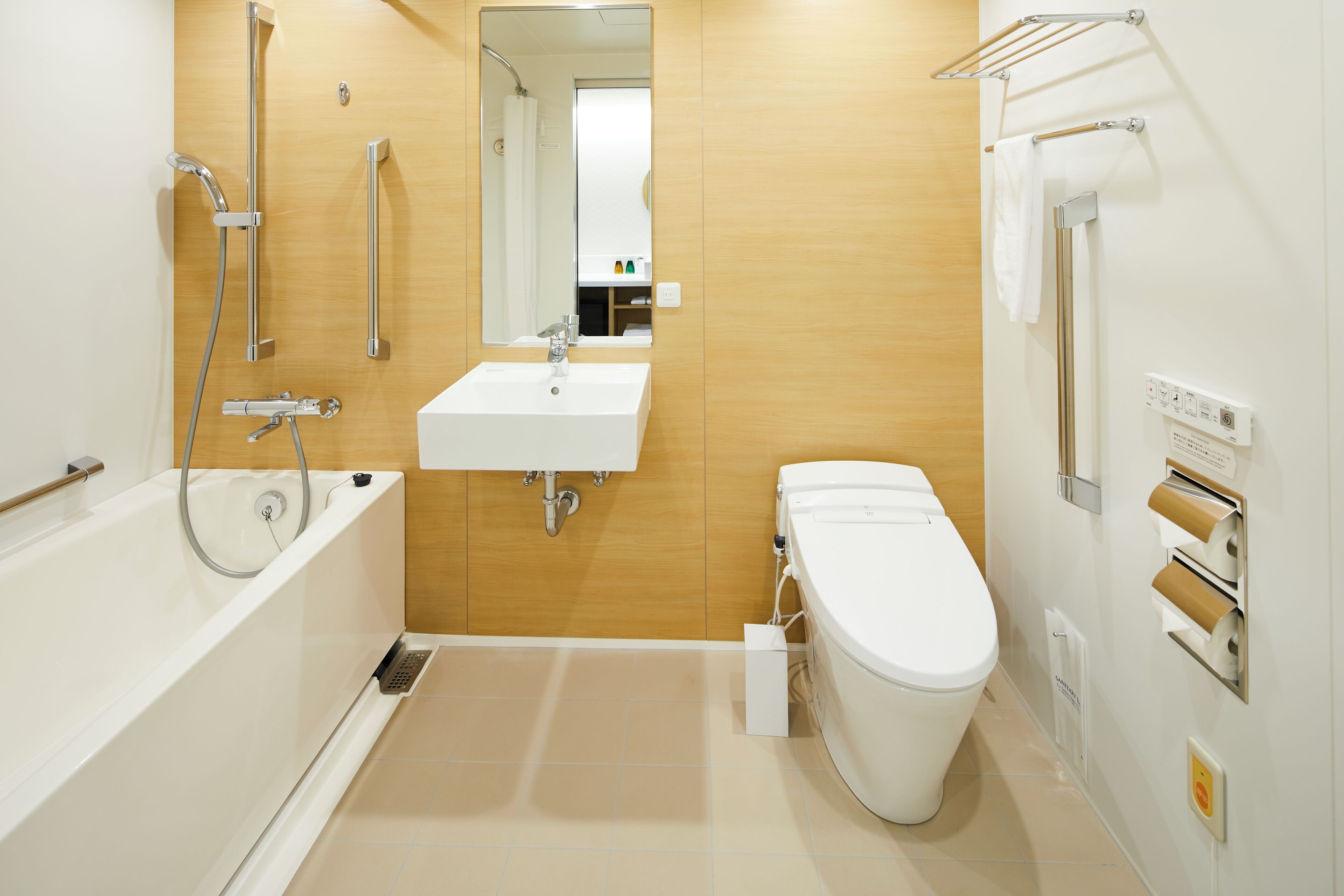 A modern bathroom with a bathtub, sink, toilet, and towel rack.