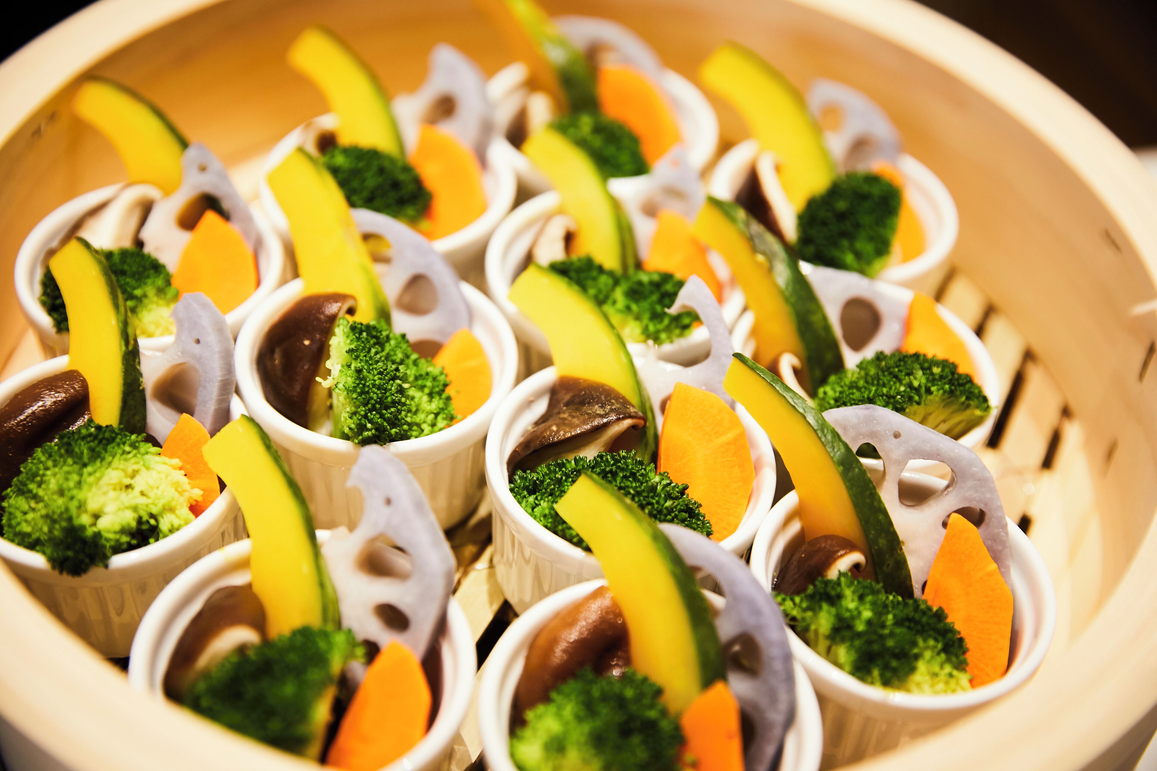 A food display with various vegetables arranged in a basket.