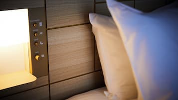 A control panel with options for room, bed, foot, and entrance, indicating a hotel room setting.