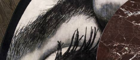 A close-up of a circular artwork featuring a detailed eye.