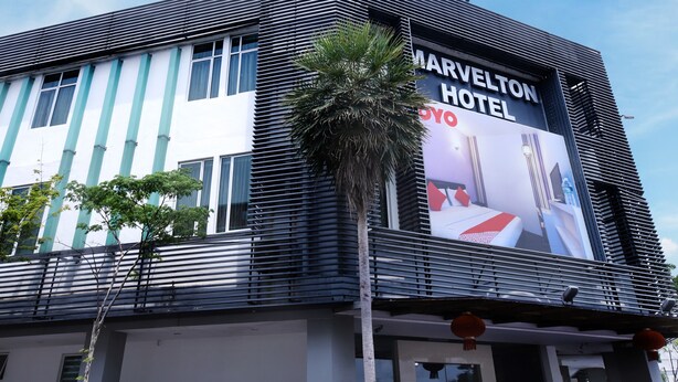 A modern hotel building with a prominent sign for Marvolton Hotel.