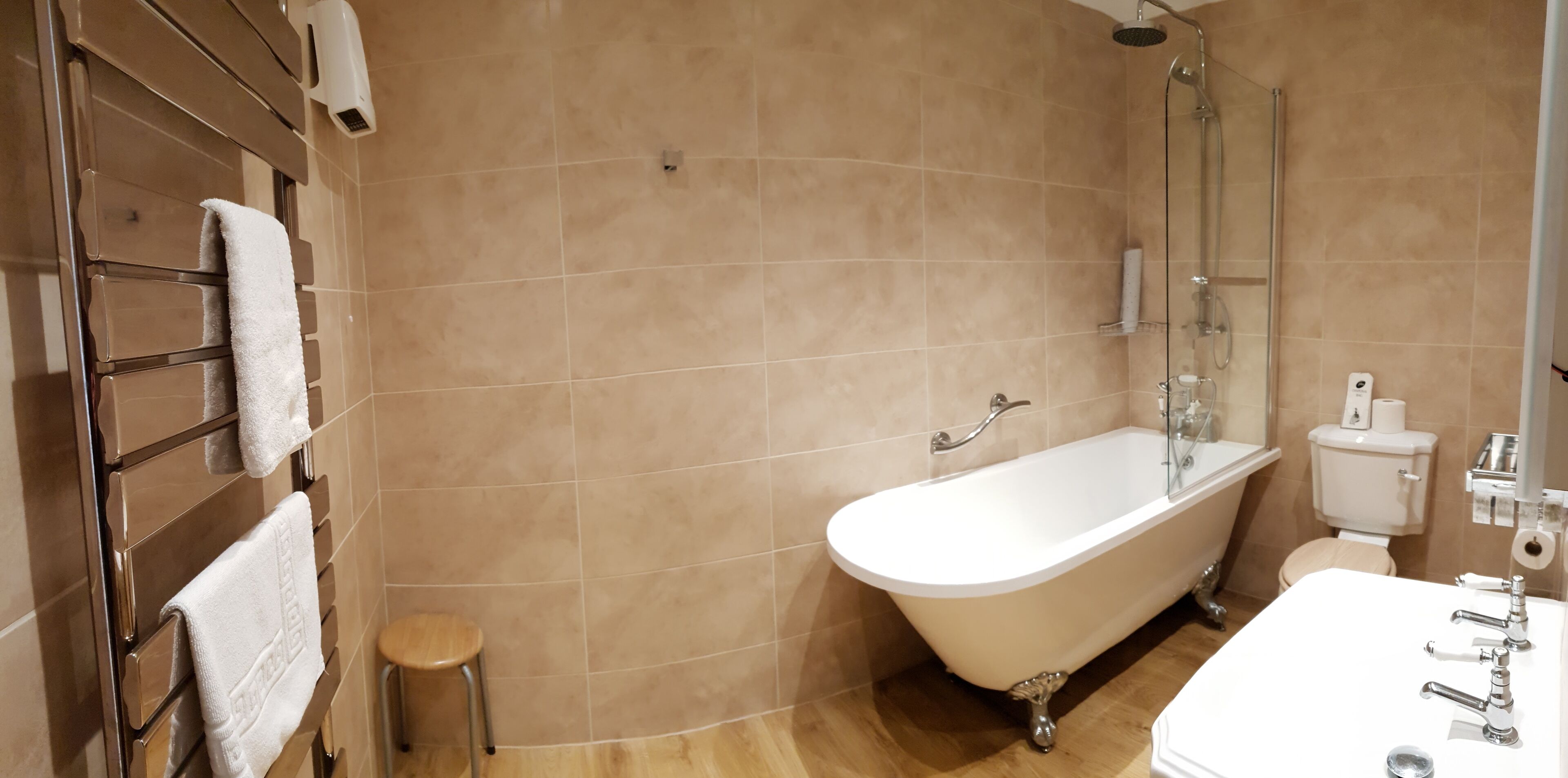 A bathroom with a bathtub, toilet, and sink.