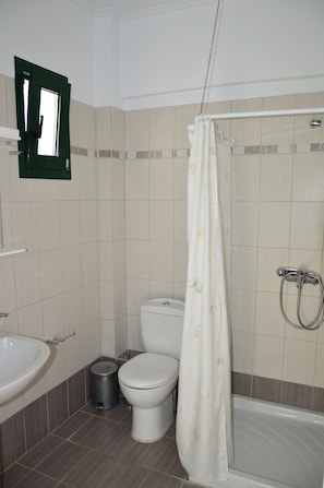 Un baño con inodoro, lavamanos y bañera.