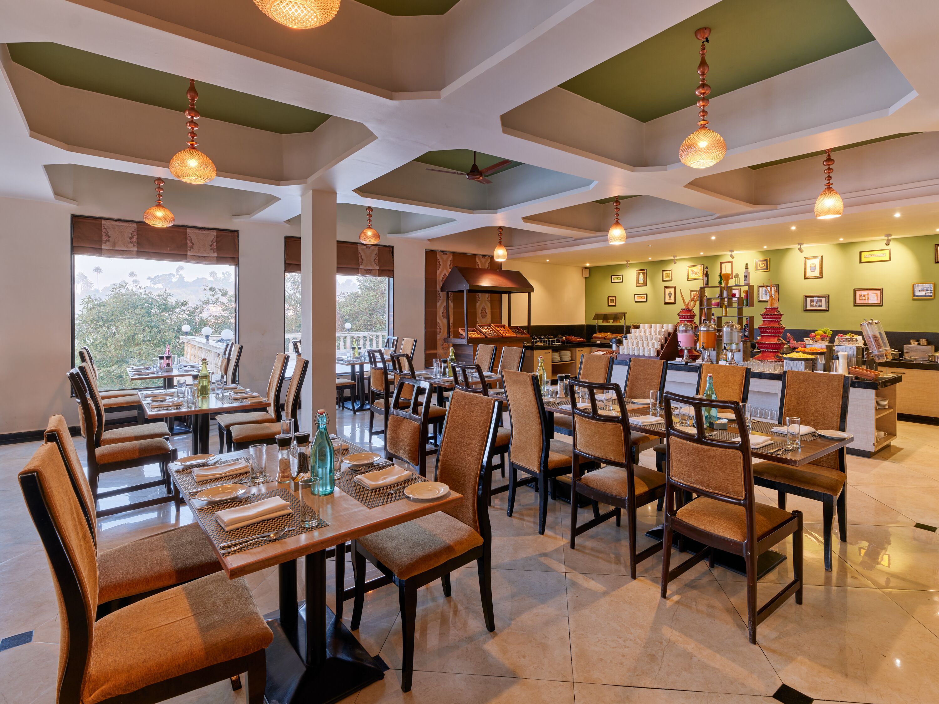 A restaurant with multiple dining tables and chairs, a bar area, and a view of the outdoors.