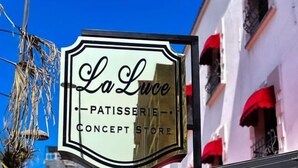 A storefront sign for "La Luce Patisserie - Concept Store" with a clear view of the street and buildings in the background. - Panderma Port Hotel (Bandirma)