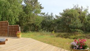 A wooden deck with a view of a forested area. - Holiday home Aakirkeby (Akirkeby)