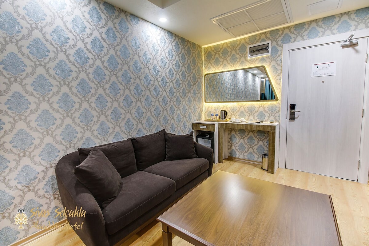 standard quadruple room | living area | lcd tv