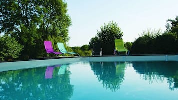 Seasonal outdoor pool, open 10:00 AM to 8:00 PM, pool umbrellas
