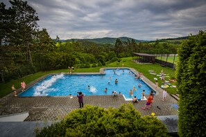 Seasonal outdoor pool, open 8 AM to 10 PM, pool umbrellas, pool loungers