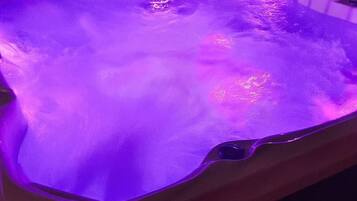 A hot tub with purple lighting.
