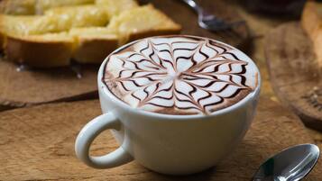A cup of coffee with latte art on a wooden table.