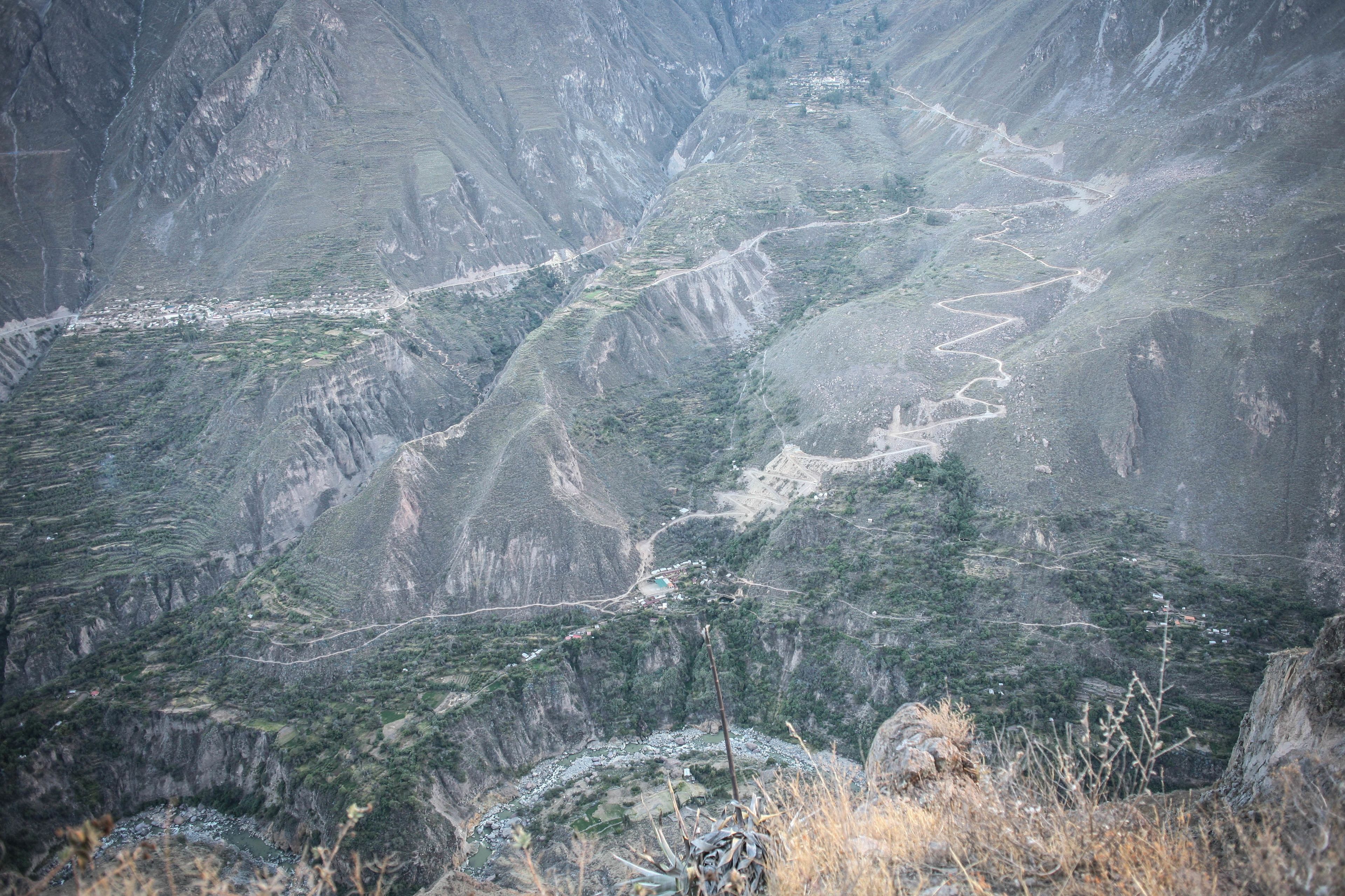 Paisaje montañoso con carreteras sinuosas y vegetación escasa.
