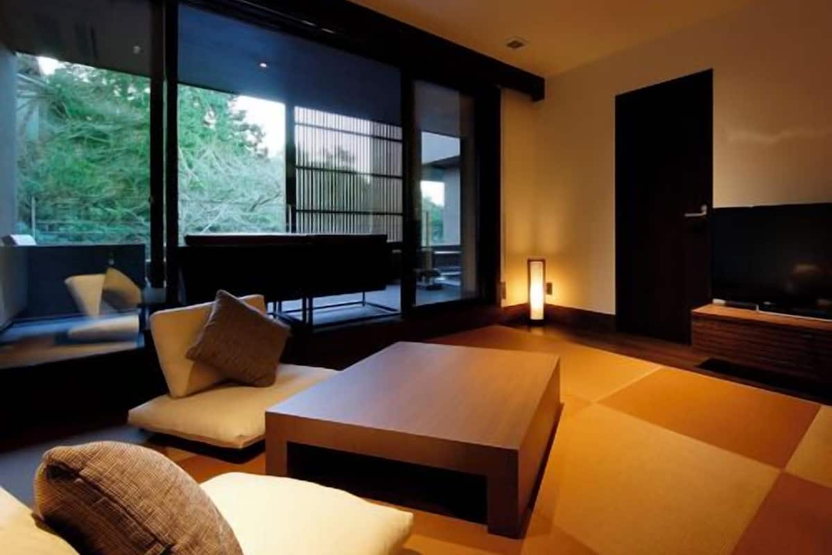 A modern living room with a sofa, a coffee table, and a television.