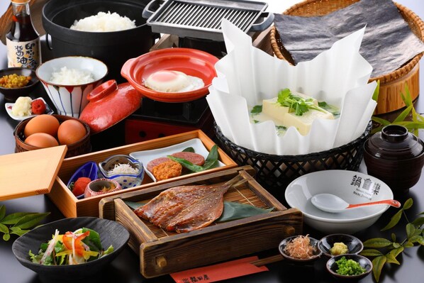 A traditional Japanese meal setup with various dishes and utensils. - Unzen Fukudaya (Unzen)