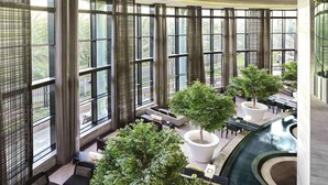 A spacious indoor area with large windows, seating arrangements, and potted trees. - Fairmont Riyadh (Riyadh)