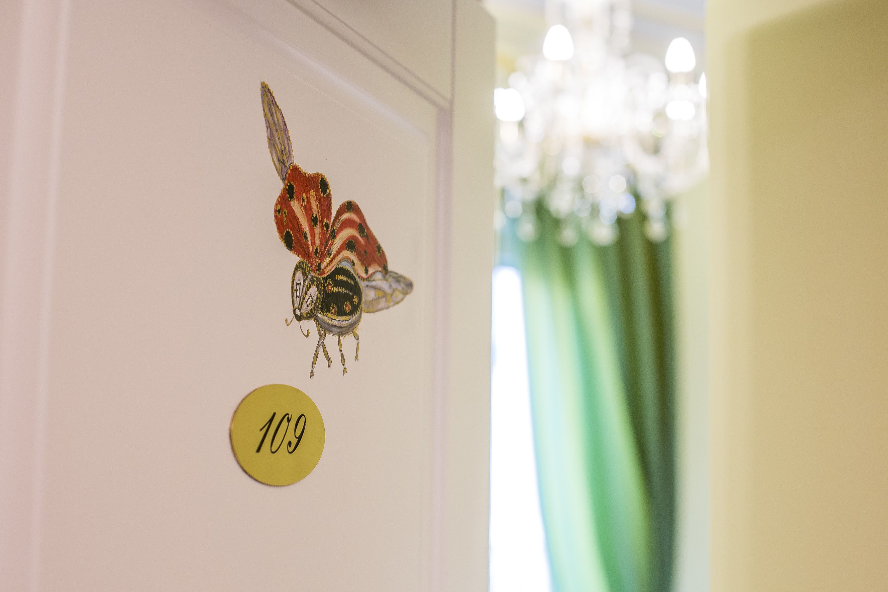 A wall with a butterfly decoration and a number sign.