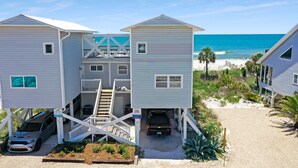 A beachfront property with multiple houses, a covered parking area, and a sandy beach. - Gulf Front, Pet Friendly, N. Cape San Blas with Screened Deck ~ Whataday (Cape San Blas)