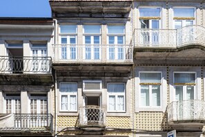 A multi-story building with balconies, windows, and a tiled facade.