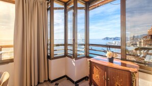 A corner room with a large bay window overlooking a cityscape and water. - Principado Arena 18-A Levante Beach (Benidorm)