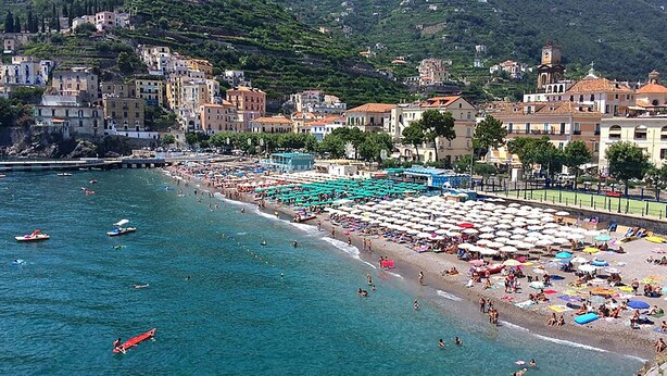A coastal town with a beach, buildings, and a mountainous backdrop. - Vicaria, Sea View, a few steps from beach by AMALFIVACATION.IT (Minori)