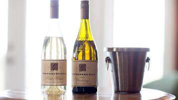 Two bottles of Youngberg Hill wine on a table with a metal bucket.