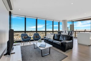 Bayview 2 Bedroom Collection | Living area | 55-inch Smart TV with satellite channels, Netflix, streaming services - Melbourne Lifestyle Apartments - Best Views on Collins (Docklands)