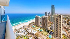 A high-rise hotel overlooking a beach with a clear view of the ocean and city skyline. - H Luxury Residence Apartments - Holiday Paradise (Surfers Paradise)