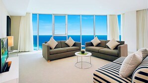 A modern living room with two sofas facing a large window overlooking the ocean. - H Luxury Residence Apartments - Holiday Paradise (Surfers Paradise)
