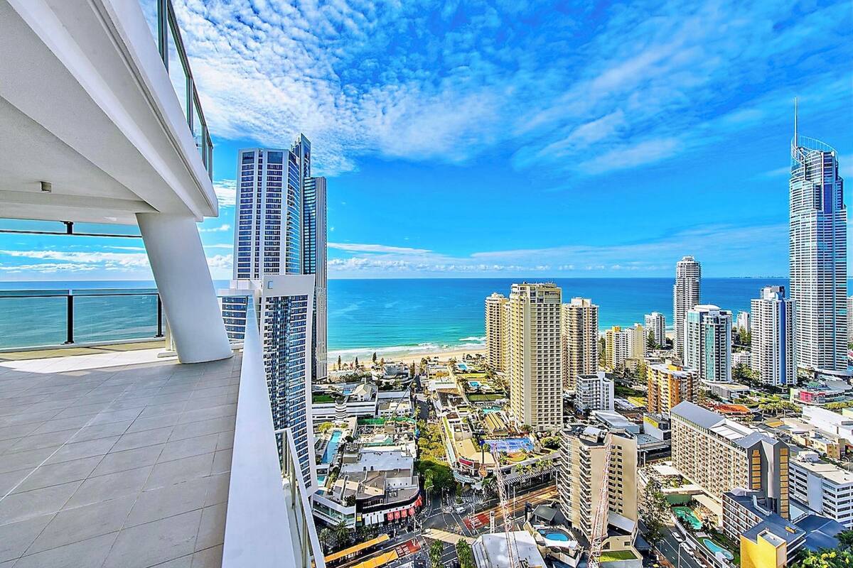 A high-rise building with a view of the beach and ocean.