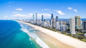 A coastal cityscape with a beachfront, high-rise buildings, and a clear sky. - Circle On Cavill Surfers Paradise Apartments-Holiday Paradise (Surfers Paradise)