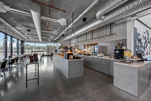 A modern kitchen with a central island, large windows, and a view of the city. - Comfort Hotel Porsgrunn (Porsgrunn)