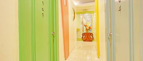 A hotel corridor with doors numbered 103, 104, and 105.