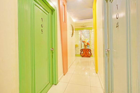 A hotel corridor with doors numbered 103, 104, and 105. - Townhouse OAK Makati Manila Near PNR Pasay Evangelista formerly VIP Suites (Makati)
