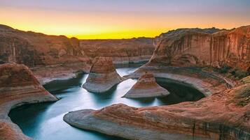 A natural landscape with rock formations and a river.
