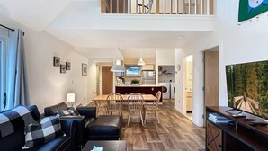 A modern apartment with a living room, dining area, and kitchen. - Village 43 | Spacious End Unit with Loft, Fireplace & Resort Amenities (Killington)