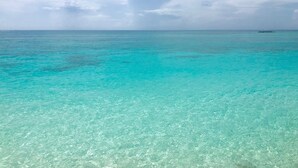 A clear turquoise sea with a distant island.