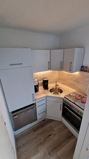 Fridge, stovetop, dishwasher, coffee/tea maker