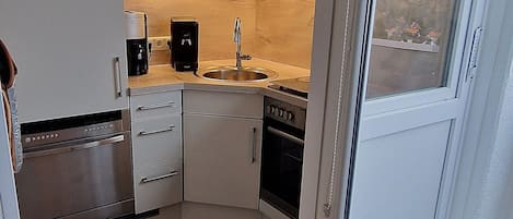 Fridge, stovetop, dishwasher, coffee/tea maker