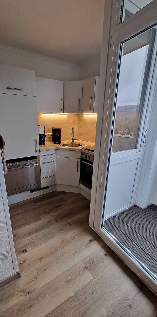 Fridge, stovetop, dishwasher, coffee/tea maker