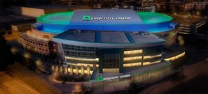 A stadium with a green roof and the text "paycom center" on the facade.
