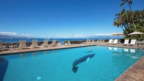 A pool with lounge chairs and a view of the ocean. - Perfect location and Unbelievable Views at Lahaina Roads (Lahaina)