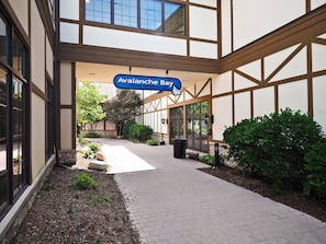 An indoor waterpark entrance with a sign reading "Avalanche Bay."