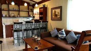 The living room, breakfast bar, and kitchen.